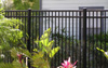EFF-20 Elite aluminum fence by flowers and ferns